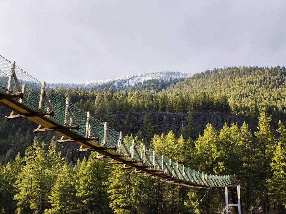 Kootenai Falls swinging bridge stretching across the Kootenai River gorge near Troy, Montana
